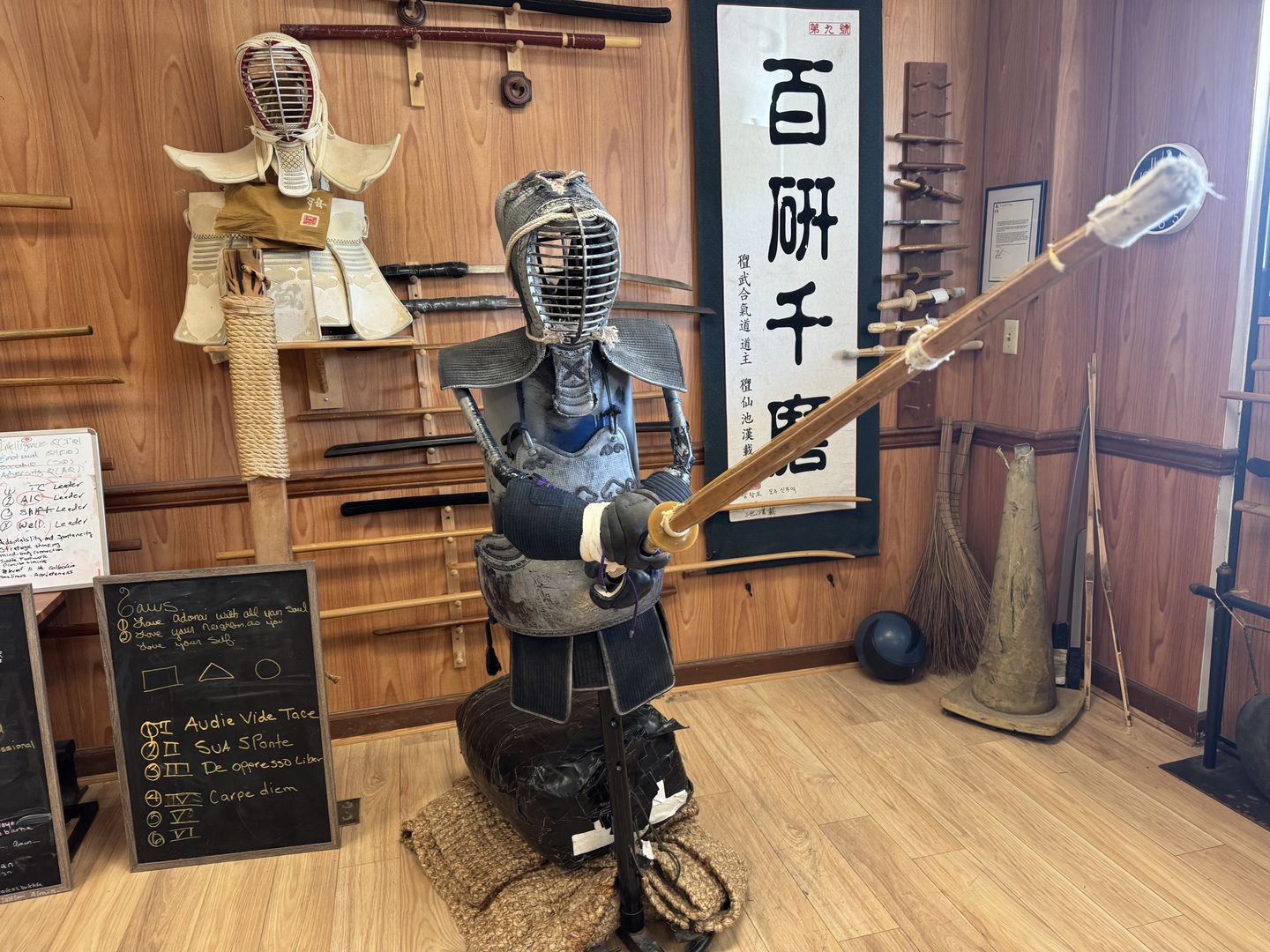 Excalibur Academy's Nashville training hall, with kendo armor, a wall of swords, and Korean calligraphy